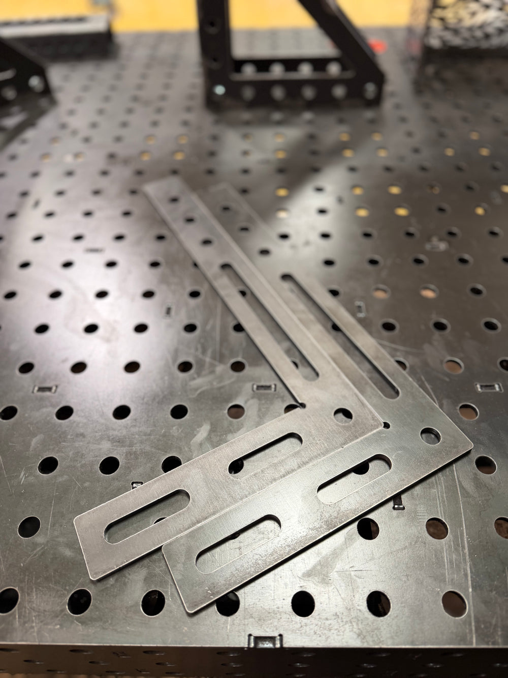 Two BPT large 90 degree welding squares, 450 x 250mm 6mm steel with slotted legs, on a BPT fixture table