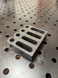Stack of BPT slotted end stops on a BPT fixture table